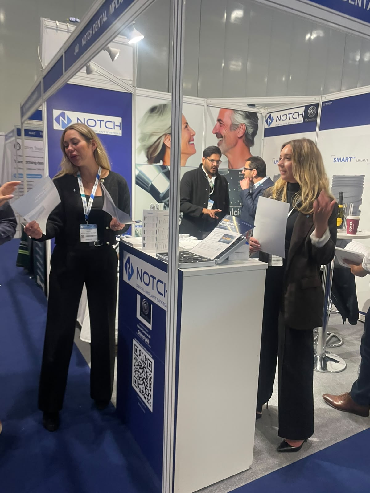 The Dentallica team talking with visitors at Stand J40