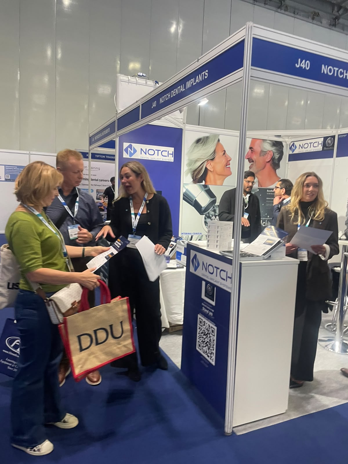 Visitors browsing the NOTCH implant range at the stand