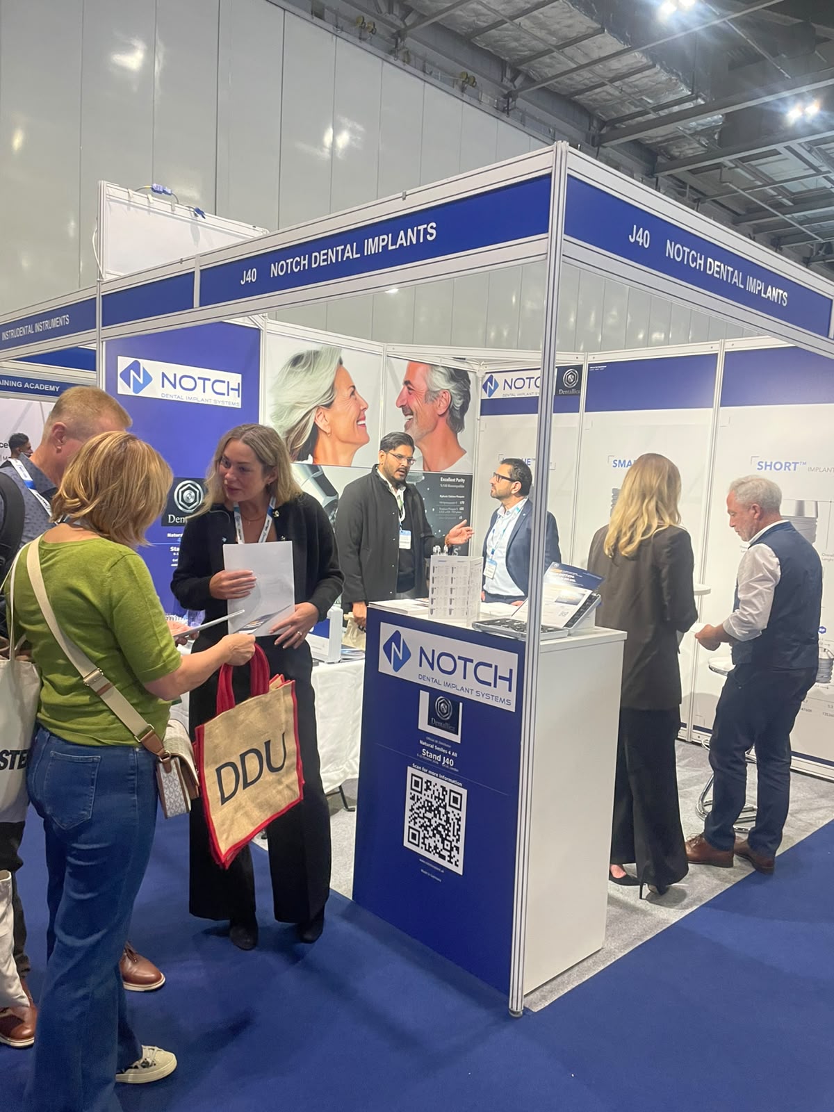 Visitors at the NOTCH Dental Implants stand, J40
